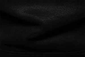 Macro detail of high-quality black suede fabric texture with fine granular weave