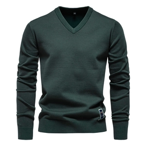 Detail of dark green V-neck knit sweater showing the neckline texture and size S tag