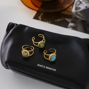 Detailed close-up of vintage adjustable gold rings with turquoise and green stones