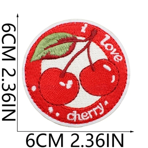 Detail of 6cm round cherry embroidery patch with I Love Cherry text and green leaves