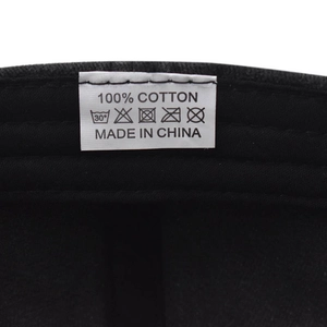 Detail shot of the 100% cotton wash care label and fabric texture on a vintage baseball cap