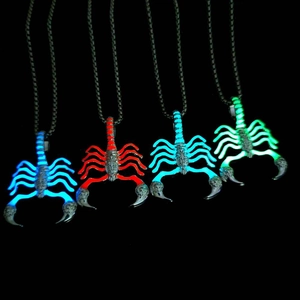Luminous scorpion pendants on black rope necklaces in blue, red, and green glow