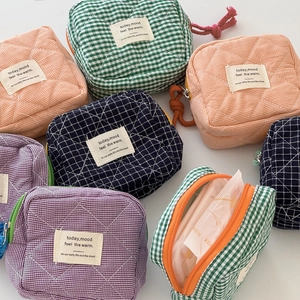 Quilted checkered organizer bags in vibrant colors with top zipper and soft fabric texture