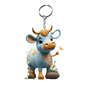 Cartoon blue highland cow keychain with gold horns and silver ring on white background