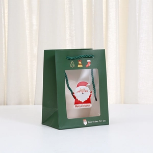 Green Christmas paper gift bag with Santa Claus print, window design and handle
