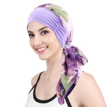 Detailed side view of light purple braided turban hat with floral printed ribbons