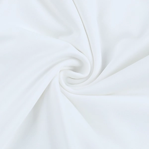 Close-up of white summer dress fabric showing soft texture and smooth pleated swirls