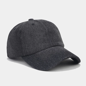 Close-up of vintage washed denim baseball cap featuring textured gray fabric and curved brim