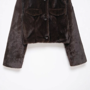 Dark brown faux fur short jacket with long sleeves and flap pockets on white background
