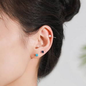 Close-up of model wearing S925 sterling silver birthstone stud earrings with colorful gemstones