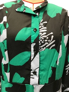 Detail of floral print shirt with turndown collar and contrast buttons on a mannequin
