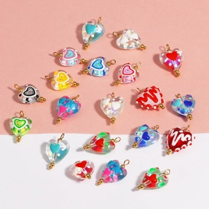 Detailed view of colorful heart-shaped glass pendant beads with intricate patterns