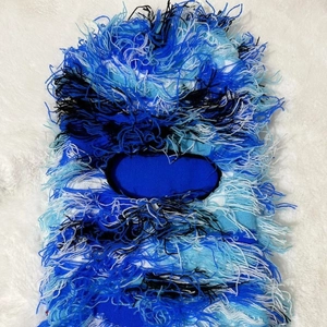 Detailed view of blue knitted balaclava featuring fringed tassel textures and blue camouflage pattern