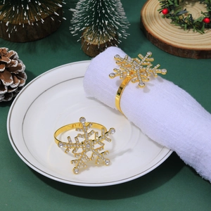 Close-up of golden snowflake napkin ring with rhinestones on festive table decor