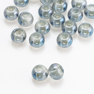 Macro detail of 8x10mm grey-blue translucent glass beads with large holes for DIY crafts