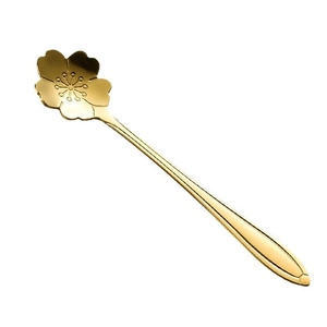 Elegant gold flower shaped stainless steel spoon for coffee and honey on white background