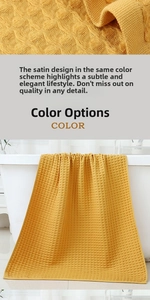 Detailed waffle texture of bright yellow cotton bath towel draped over a white bathtub