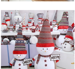 Detailed plush snowman decoration featuring a Welcome sign and festive knitted hat