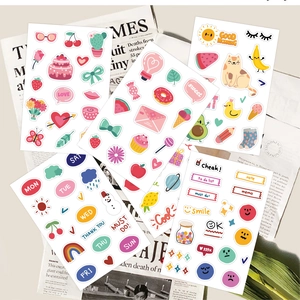 Detail of DIY planner stickers with weekly icons, food motifs, and decorative text labels