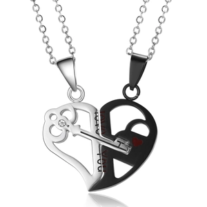 Detail of heart puzzle couple necklaces with silver key and black lock engraved Love You