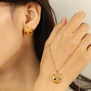 Exquisite gold owl jewelry set with black gemstone eyes featuring intricate honeycomb texture