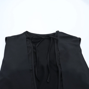 Detailed back view of a black sleeveless backless dress featuring a lace-up bow design