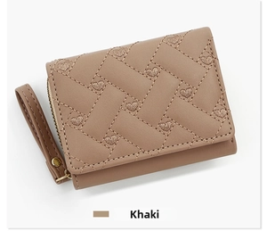 Close-up of khaki women's short wallet with heart embroidery and quilted diagonal patterns