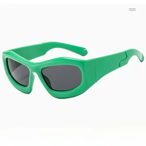 Detail of bright green bubble frame sunglasses with wavy temples and dark lenses