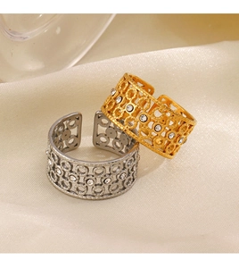 Detailed macro view of 18K gold and silver lace rings with zircon on satin fabric