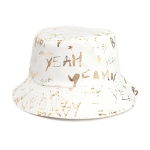 Detailed view of white bucket hat with golden graffiti style lettering YEAH and BABY print