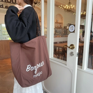 Detail of leopard print tote bag featuring Bonjour magic text in a warm cafe setting