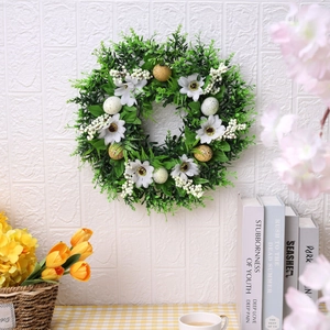 Easter wreath with artificial green leaves, white daisies, and spotted pastel eggs decoration