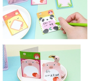 Detailed view of cute animal sticky notes in panda and pig shapes with grid patterns