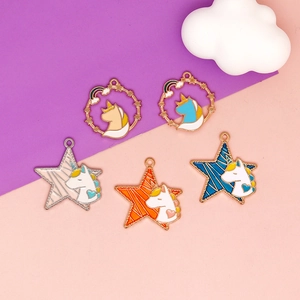 Macro detail of colorful gold alloy enamel unicorn pendants for DIY jewelry crafting