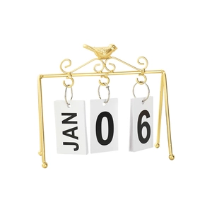 Minimalist gold bird perpetual calendar with metal frame and flip date cards on white background