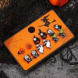 Halloween earring set with pumpkin, ghost, and bat designs on themed orange card