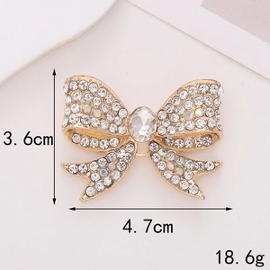 Zinc alloy gold bow charm with clear rhinestones and size measurements 4.7cm x 3.6cm