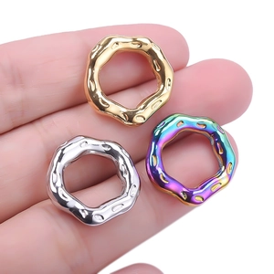 Close-up of lava texture hollow pendants in gold, silver, and rainbow 18k plated finish