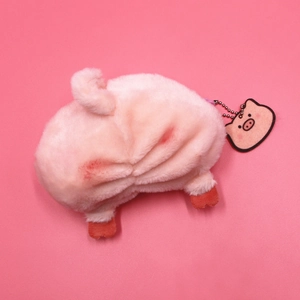 Detail view of pink plush pig coin purse back with curly tail and metal bead chain