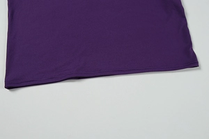 Detailed close-up of dark purple dress hem with professional double-stitched sewing