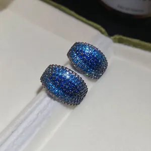 Sparkling blue zircon C-shaped stud earrings in a luxury velvet jewelry box