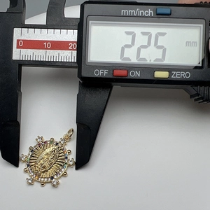 Macro shot showing 22.5mm diameter of gold Virgin Mary pendant with colorful cubic zirconia