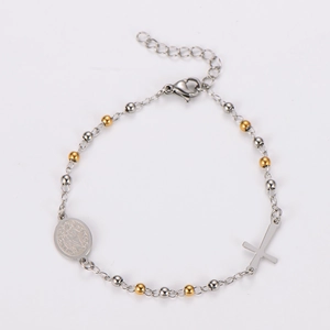 Detail of bicolor beaded religious bracelet with saint medal and crucifix pendant