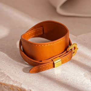 Close-up of brown faux leather double wrap bracelet with adjustable gold buckle detail
