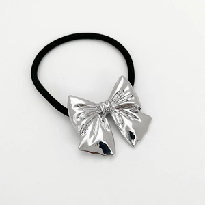 Detail of high-elastic black hair tie featuring a polished silver alloy bow decoration
