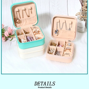 Detailed interior view of a portable PU leather jewelry box with slots for rings and necklaces
