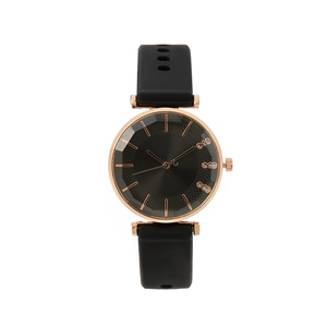 Minimalist quartz watch with rose gold case, dark grey dial and black silicone strap