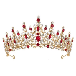 Detailed view of golden princess crown with sparkling red gemstones and clear crystals
