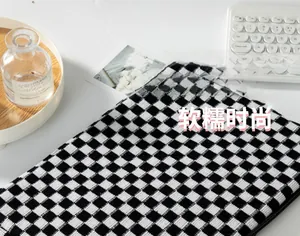 Detail of checkered knit storage bag showing large capacity and soft fabric texture