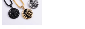 Detailed close-up of hypoallergenic sun and moon pendants in black, gold, and silver finishes
